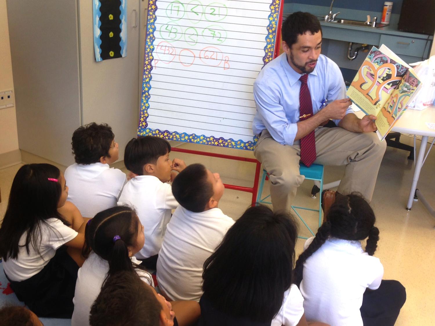 Penn State alumnus Sergio Santiago reads a book to students as a Teach For America teacher
