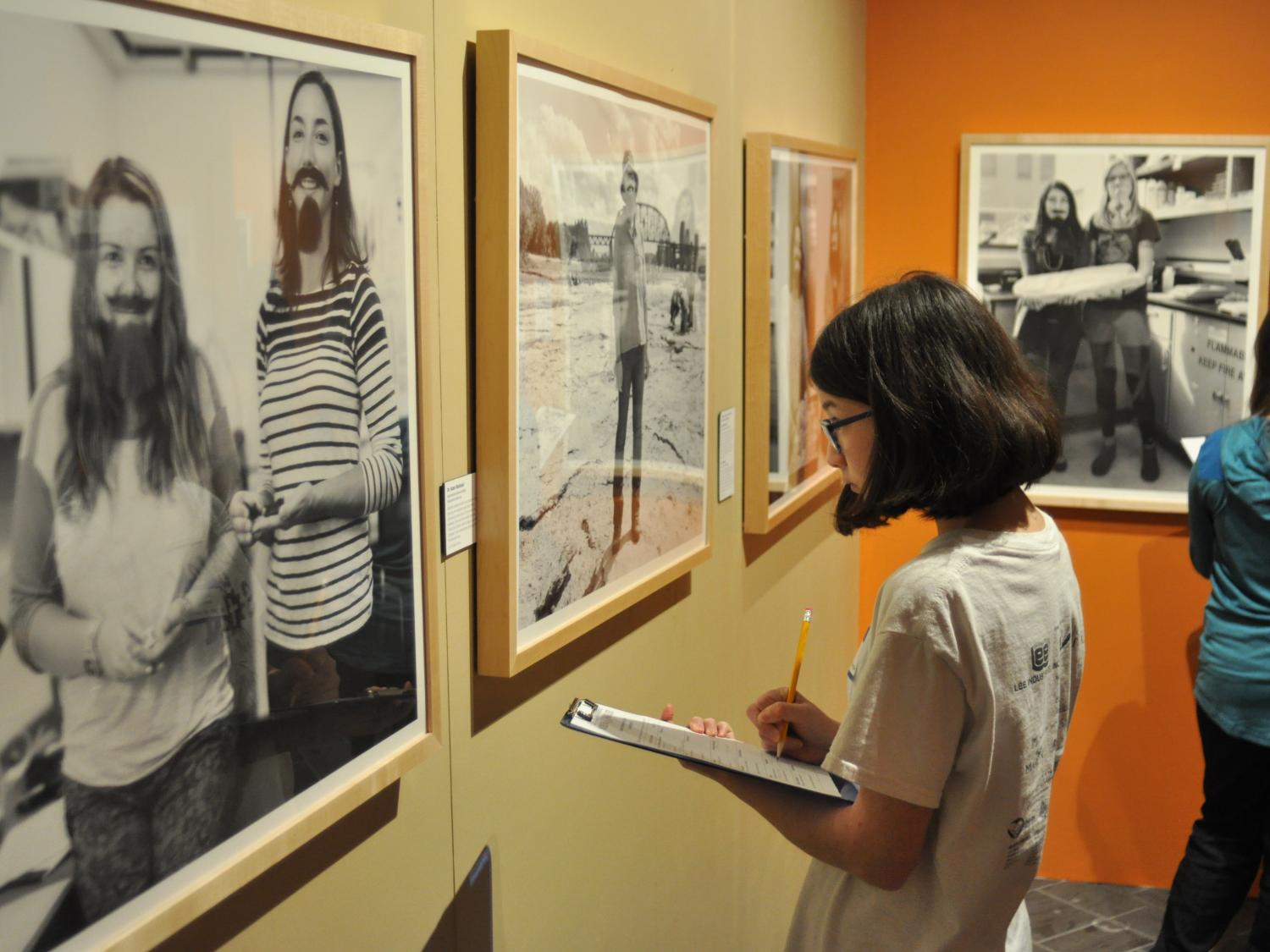 A student visits The Bearded Lady Project exhibit in the Earth and Mineral Sciences Museum & Art Gallery 