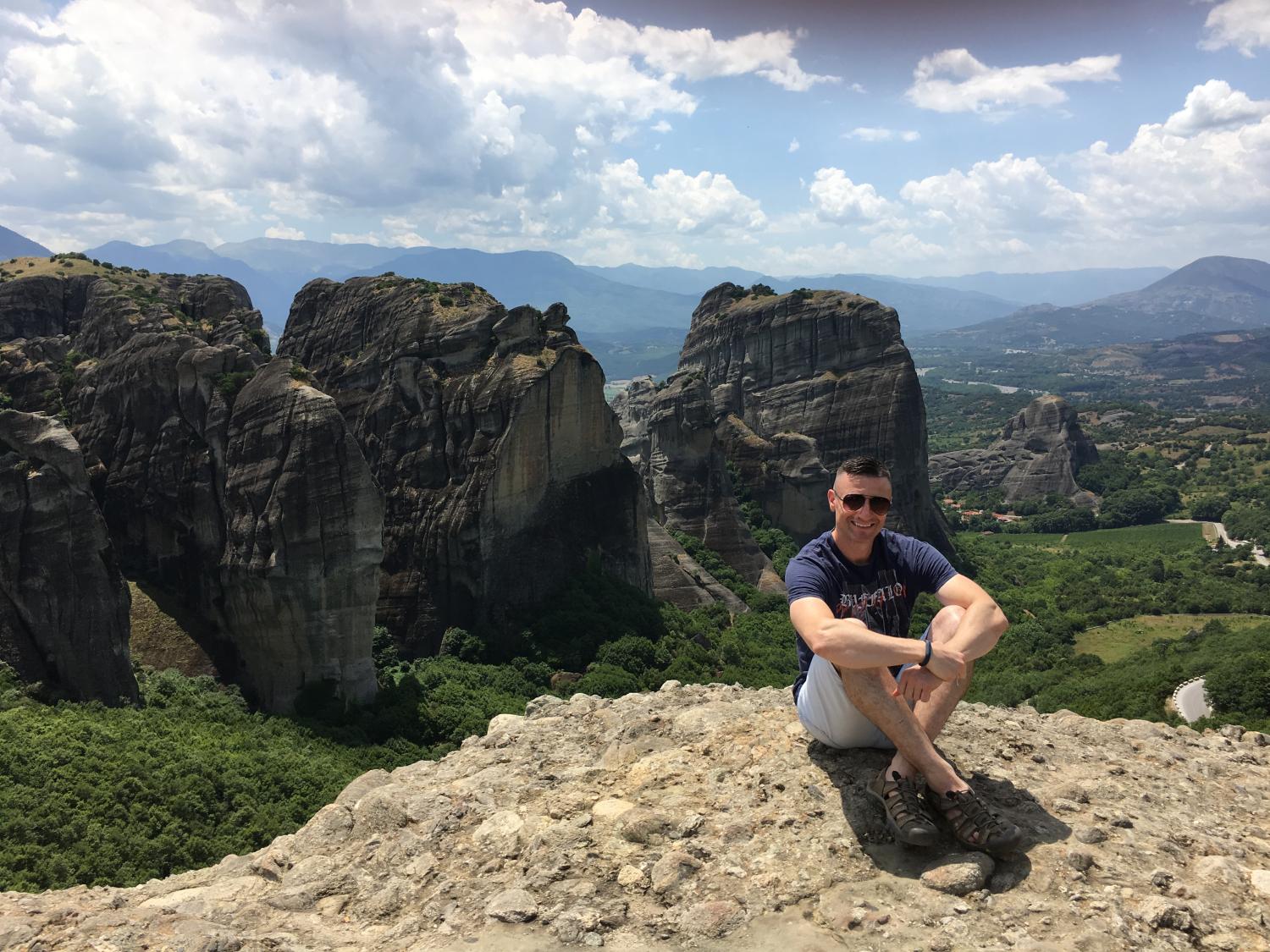 Aris Karagiorgakis, assistant teaching professor of psychology, at Meteora, a set of 13th c. Eastern Orthodox monasteries outside of Athens, Greece. His Summer 2020 class will visit the UNESCO World Heritage site.