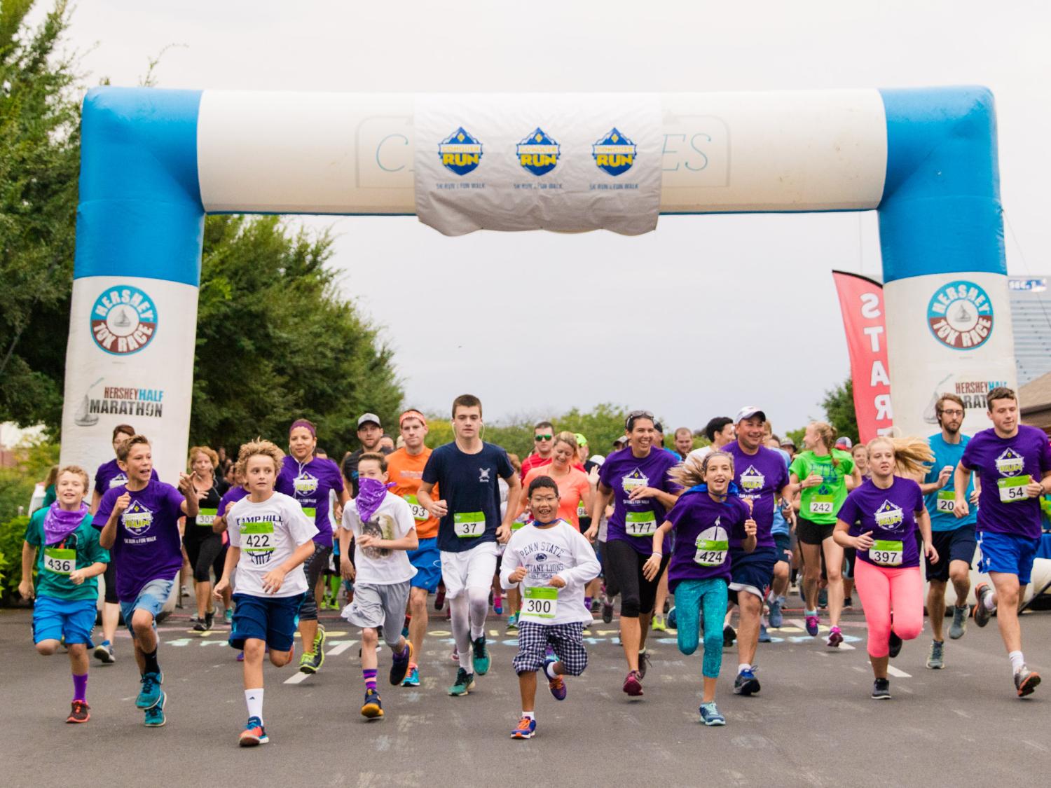 Runners, including adults and children, embark from the starting line of the 2016 Conquer Run at Hersheypark.