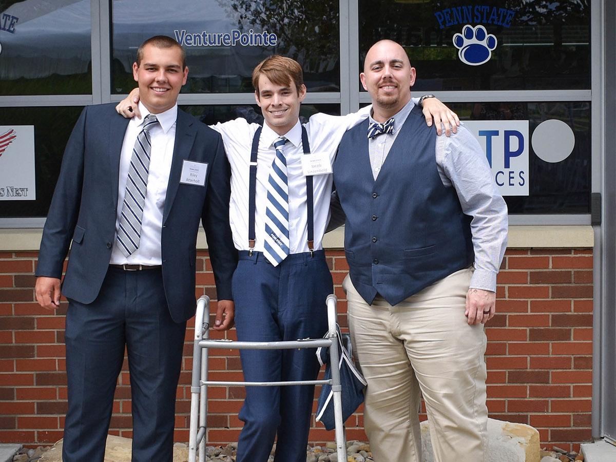 Three men standing in front of a building at the eCenter@LindenPointe