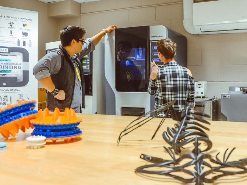 Students wait for 3D printed models to finish in lab space