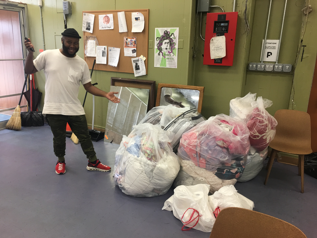 Tate Tippett of Prevention Point Homeless Shelter receives bedding from Penn State Abington's end-of-year recycling drive