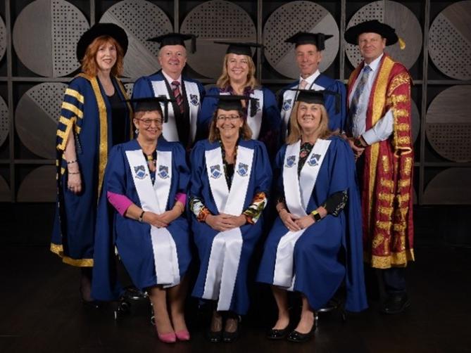 A group of professors posing for a photo