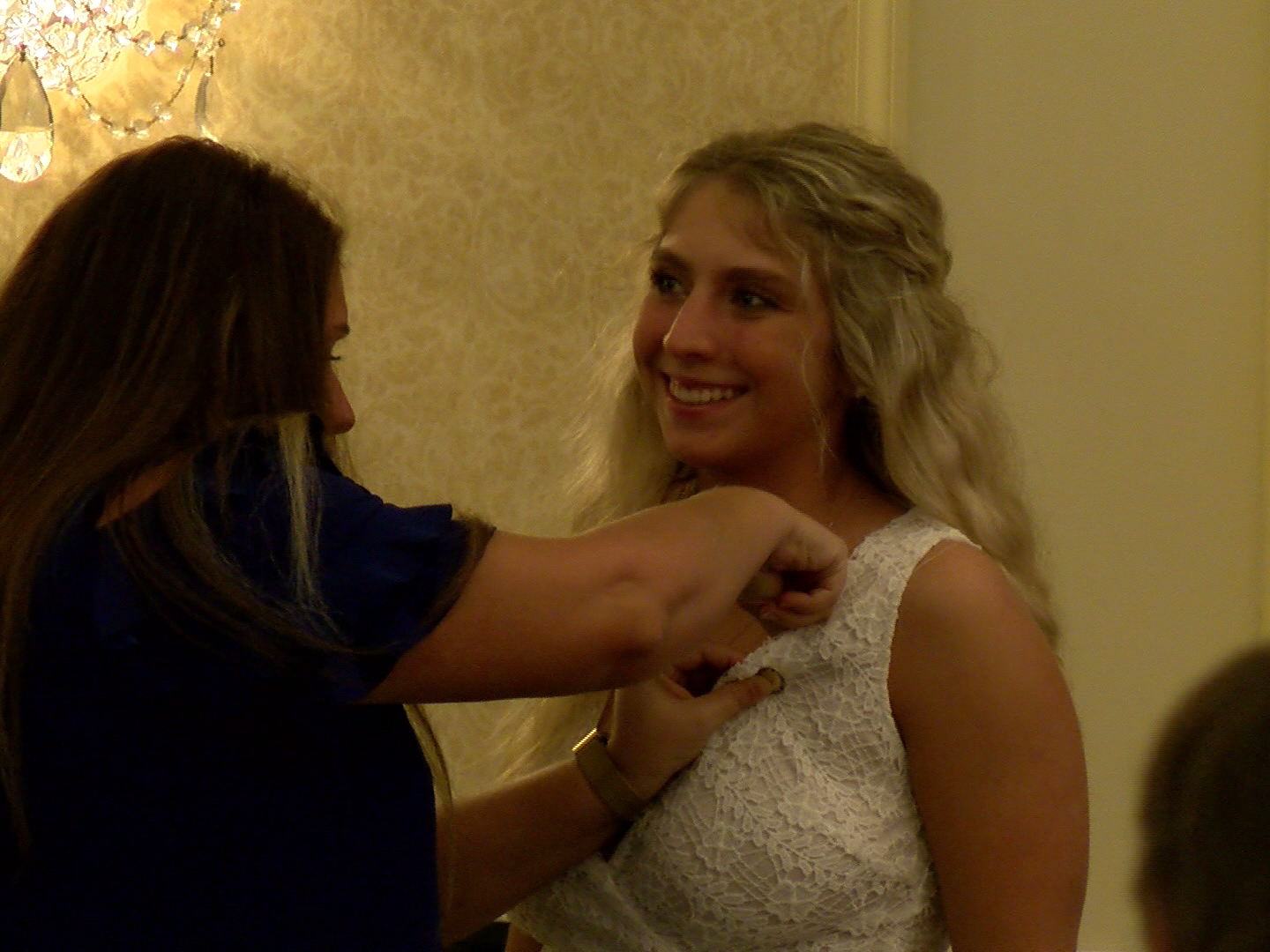 A Penn State Behrend nursing graduate receives a pin during the college's pinning ceremony.