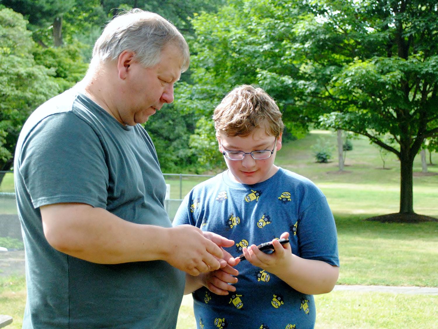John Knox and his son look for Pokemon Go characters at Penn State Behrend