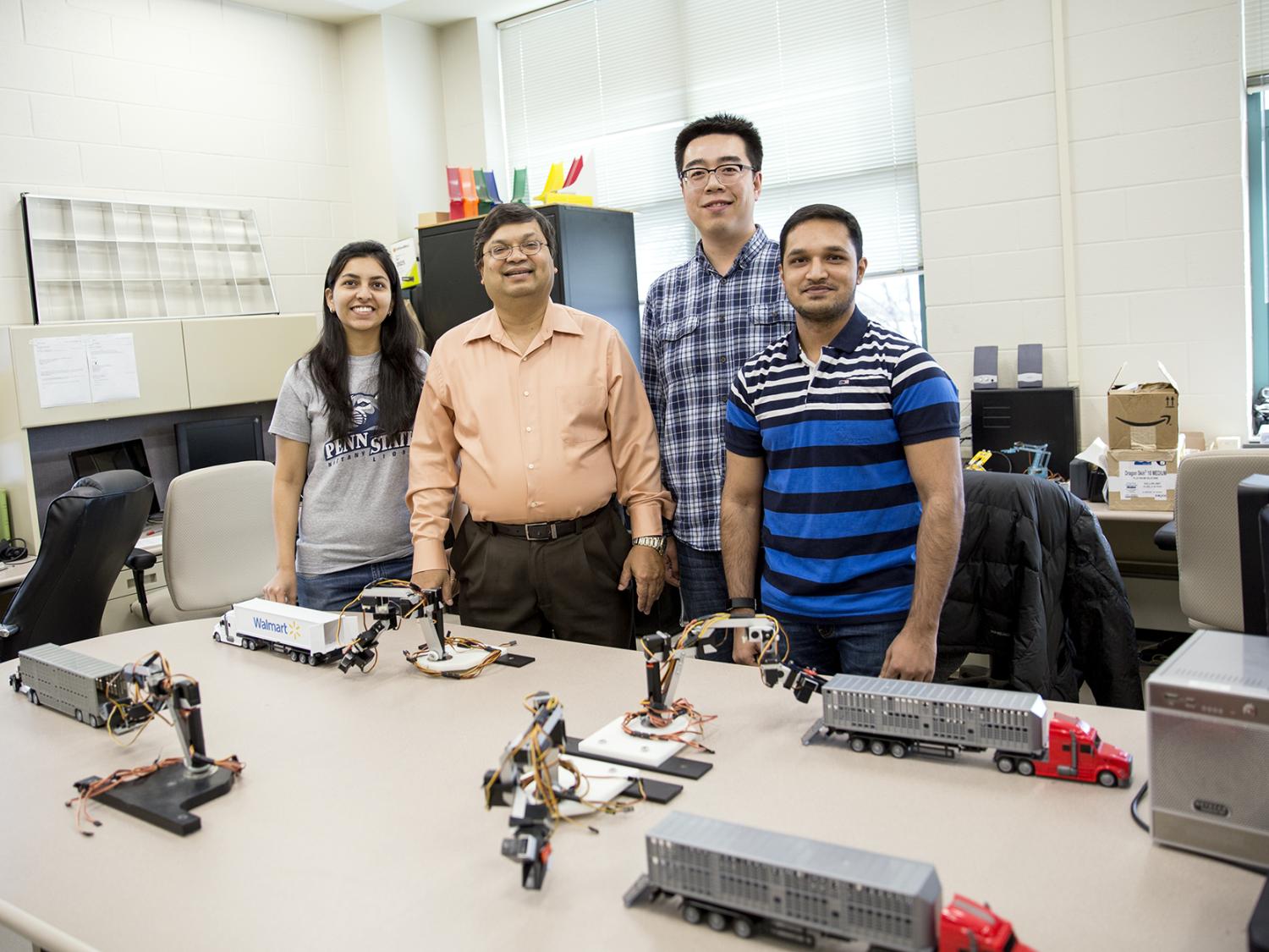 Vittal Prabu (second from left) and Rakshith Badarinath (far right) in Prabhu's research lab.