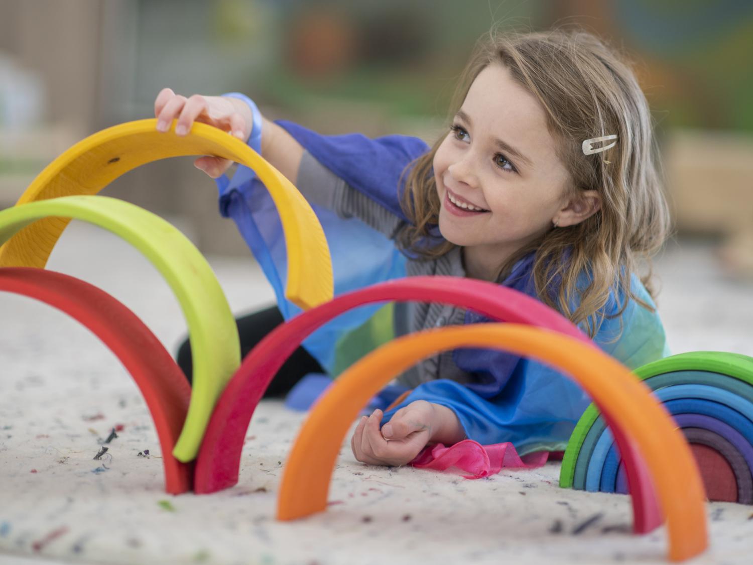 A young child playing with colorful toys