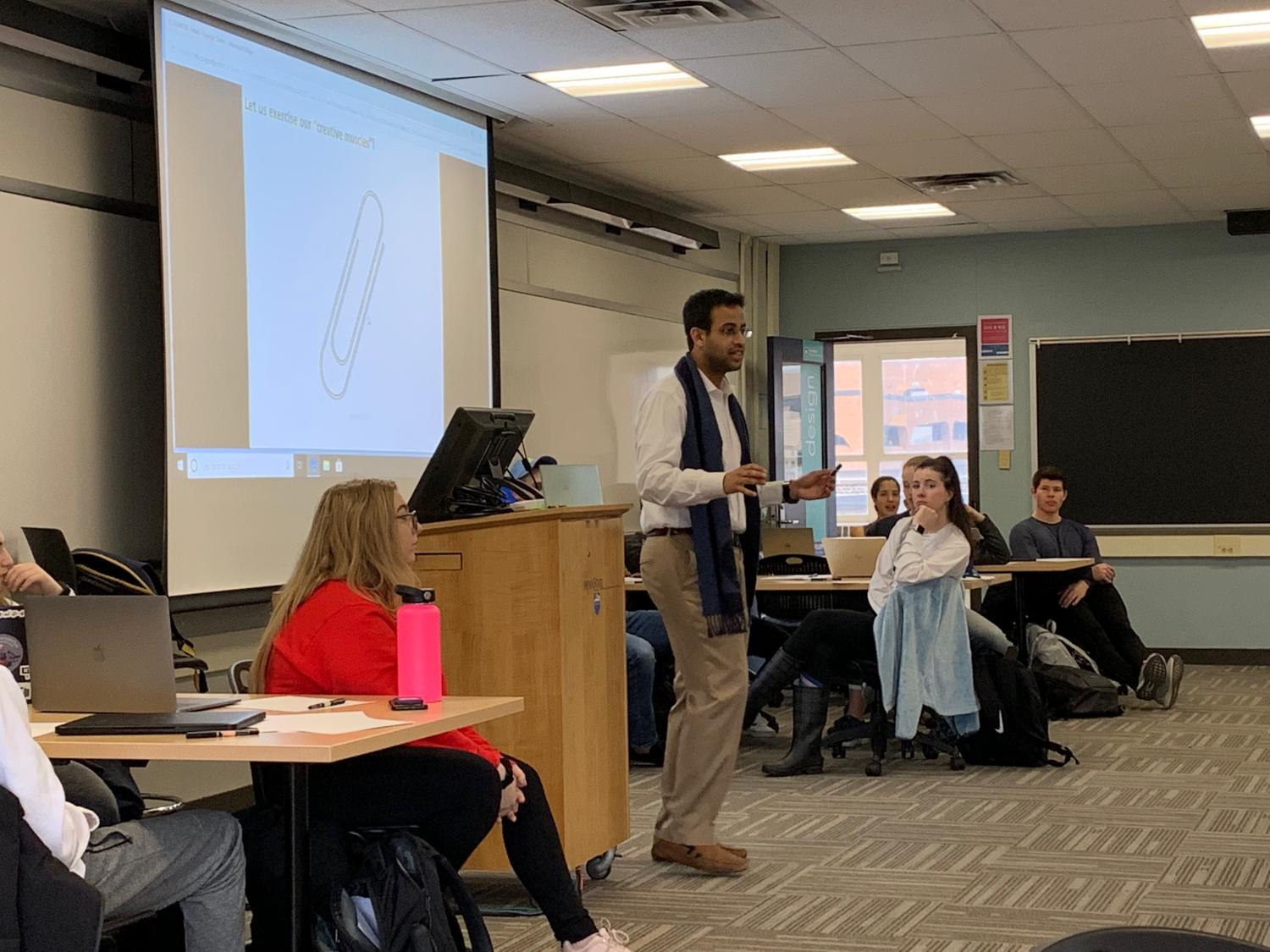 Man teaches in room with students.