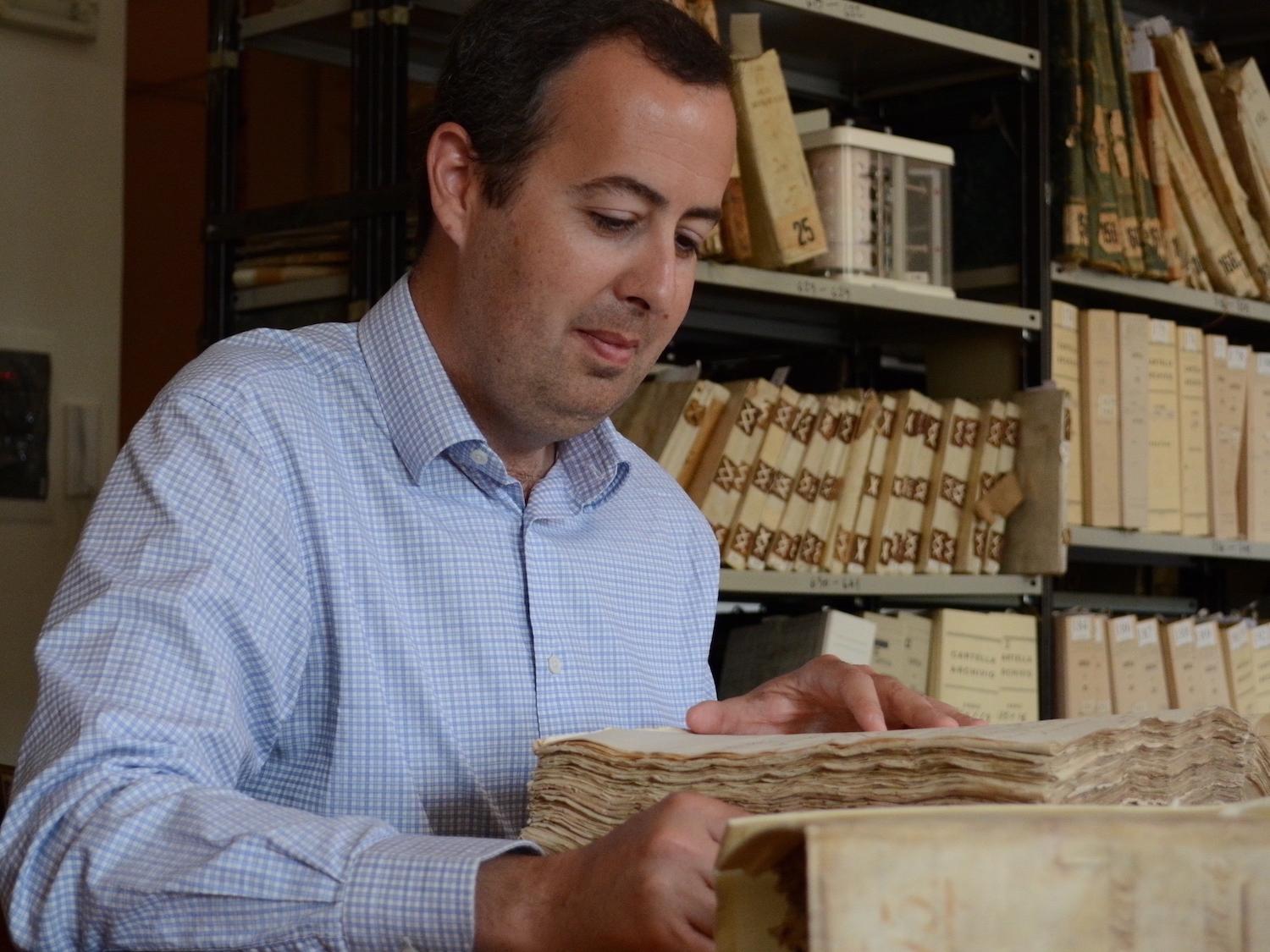 Robin Thomas looks through an old book.