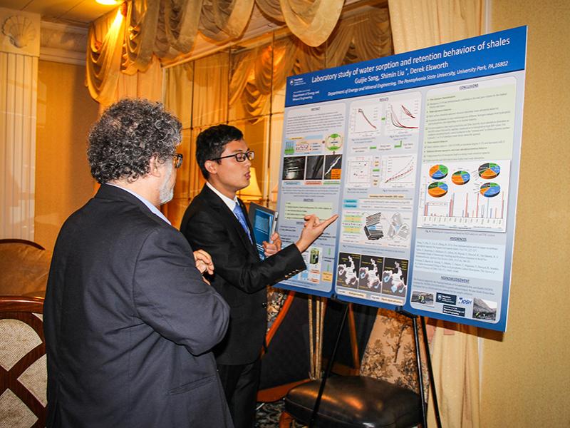 Guijie Sang, a student in the John and Wille Leone Family Department of Energy and Mineral Engineering, discusses his research with Semih Eser, professor of energy and geo-environmental engineering, at the 2018 Research Showcase.