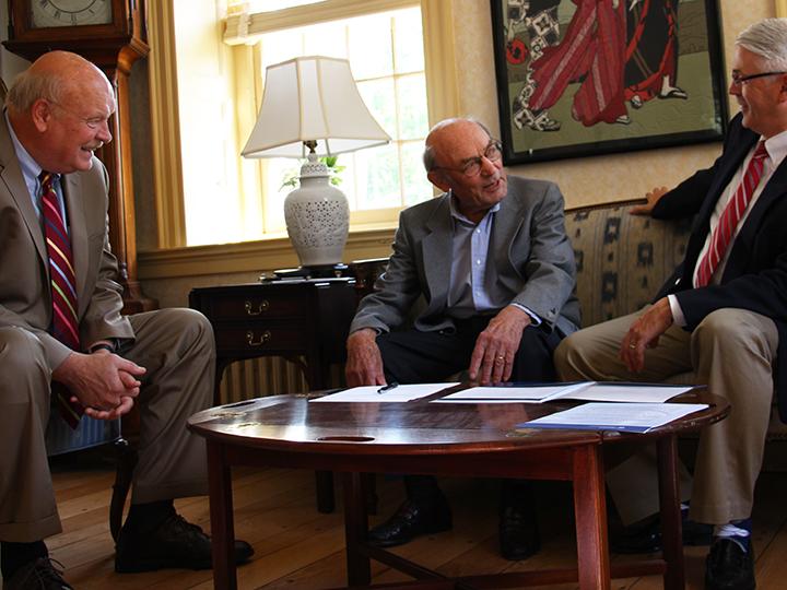 Rolf Schmidt signs agreement to create a new scholarship.