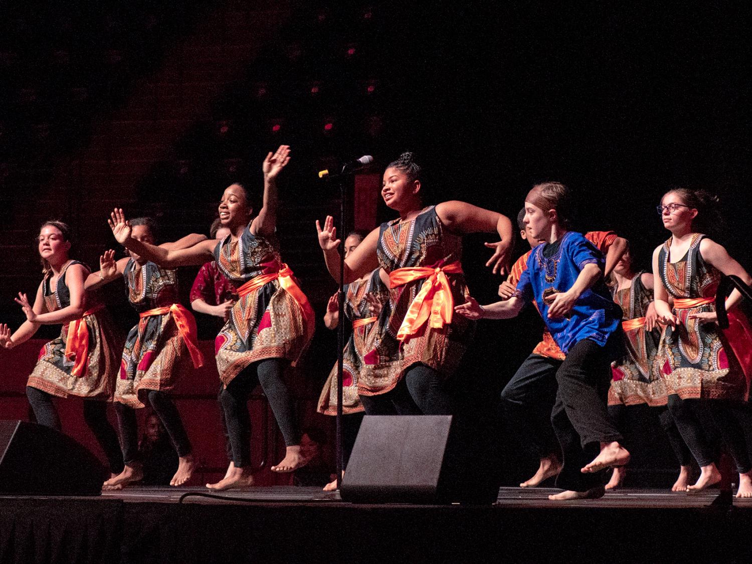 A group of students dancing on a stage
