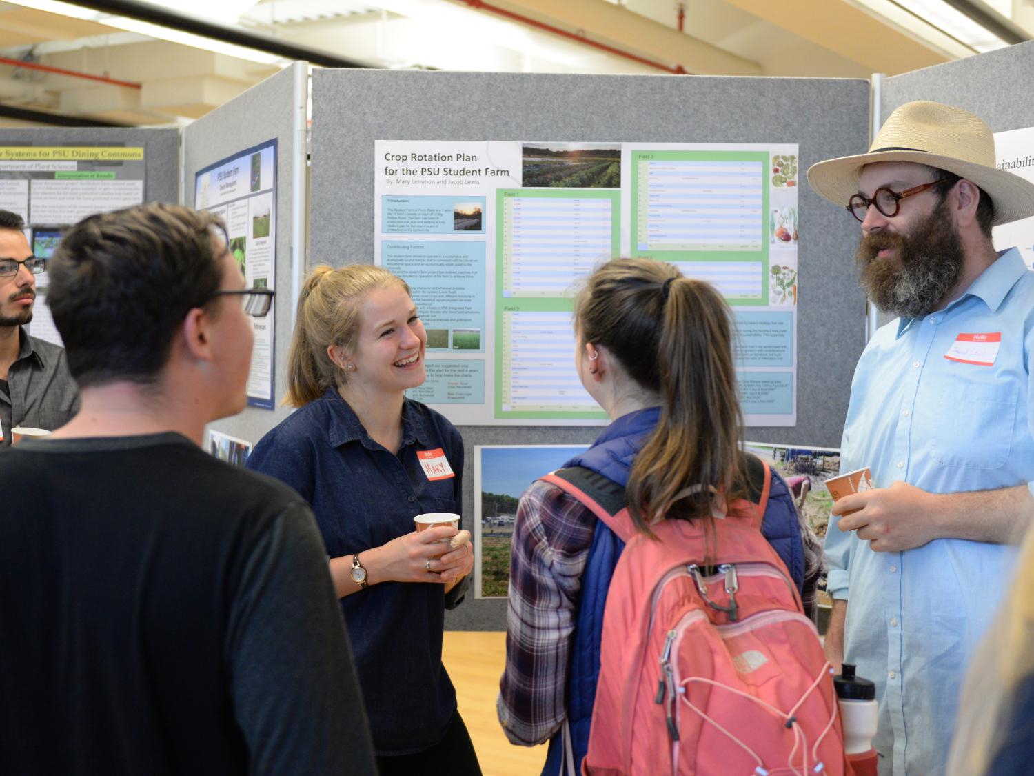 Students discuss a poster at the 2017 Campus and Community Sustainability Expo