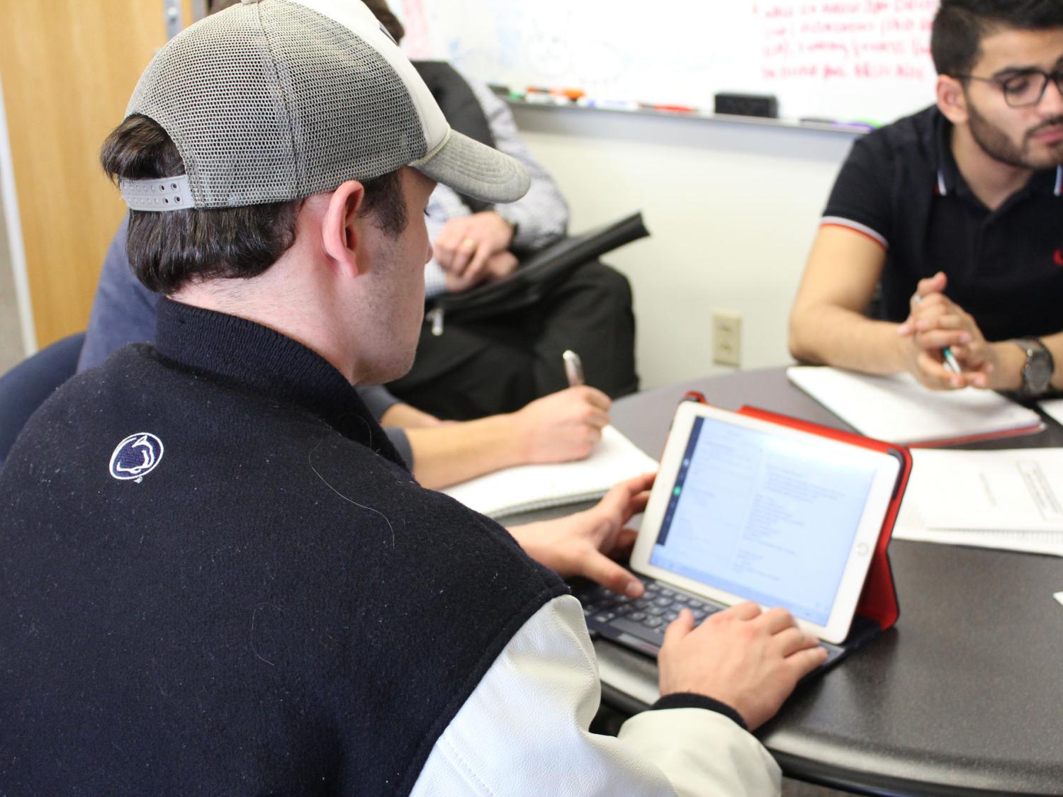 Industrial engineering students meeting with Fleet Operations employees