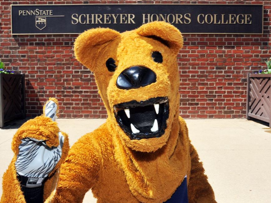 Nittany Lion mascot in front of Schreyer Honors College