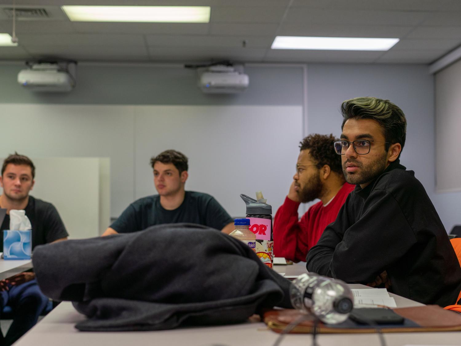 Four students watching presentation