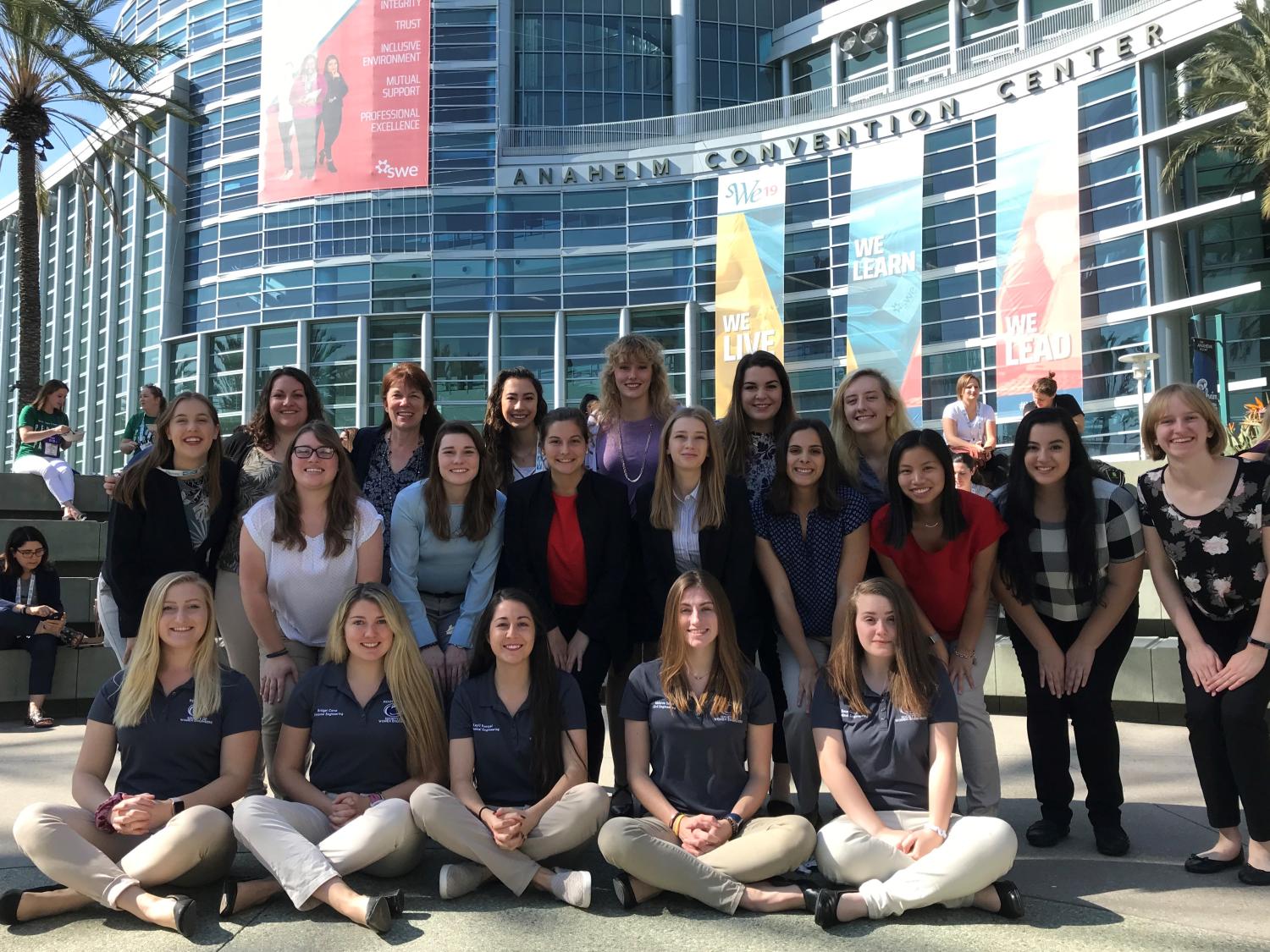 group of female students pose outside of convention center