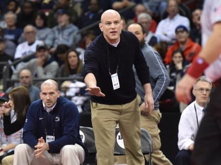 Penn State wrestling coach Cael Sanderson gives instruction from mat-side.