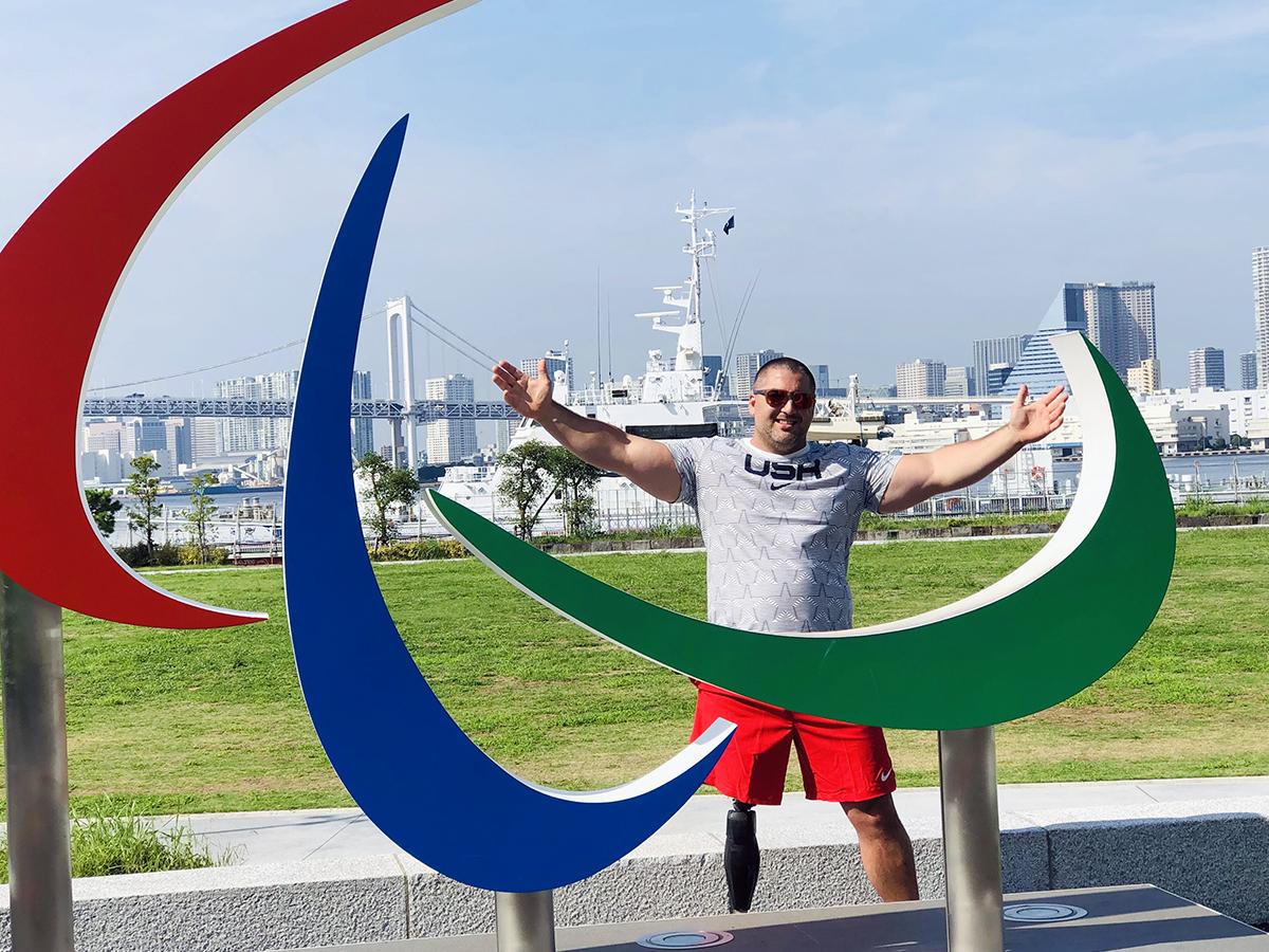 Jake standing in front of Paralympic sculpture in Tokyo 