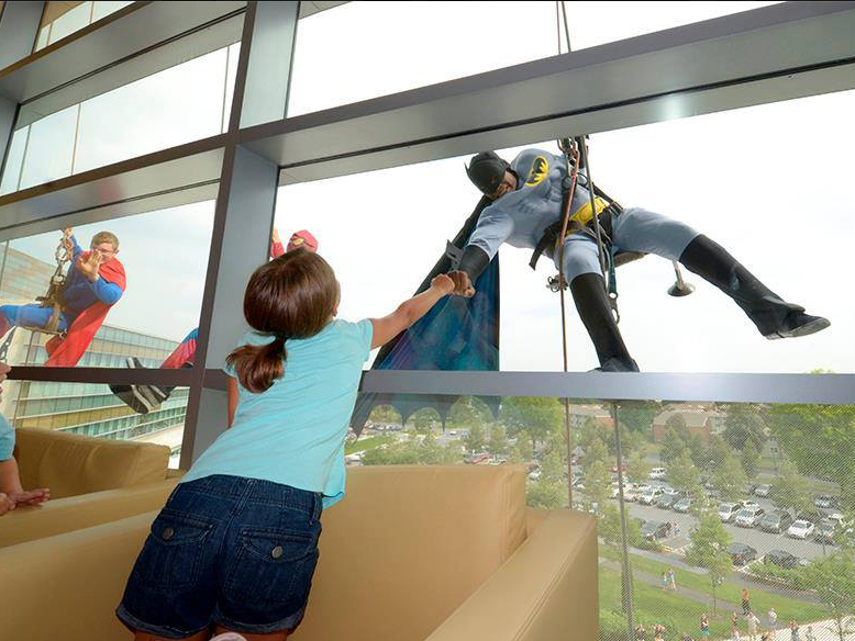 A child gives Batman a fist bump 