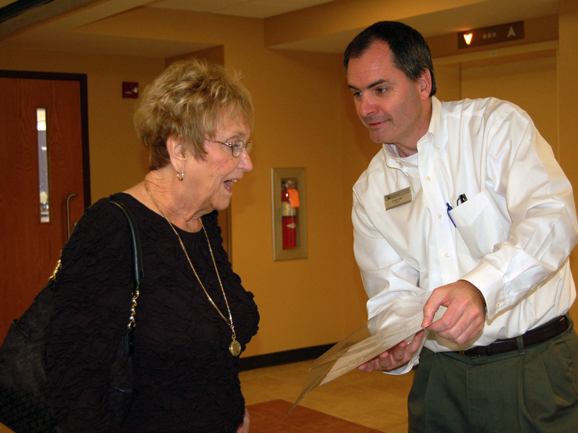 Conal Carr shows Daisy Reiter her name on a May Day brochure