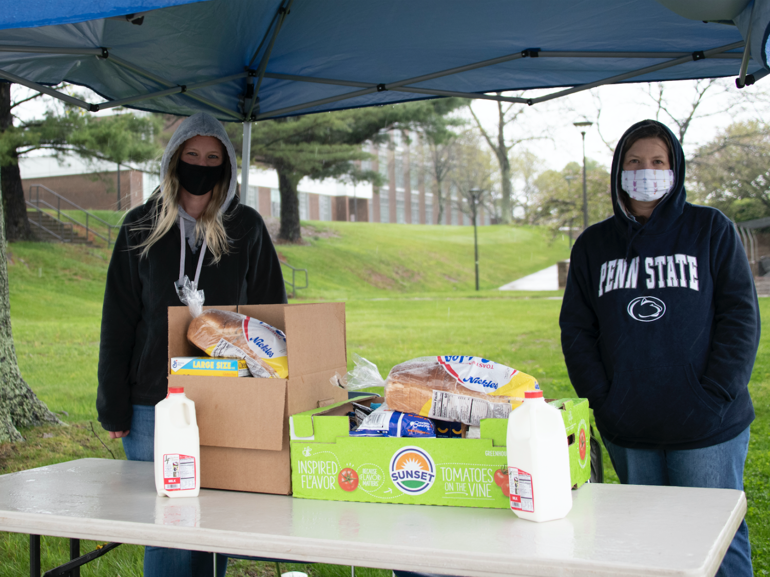 Amanda Collins, mental health counselor, and Ronette Poorbaugh, campus nurse, provide drive-thru donations from the campus food pantry to students in need.