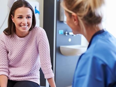 A woman talks with a physician