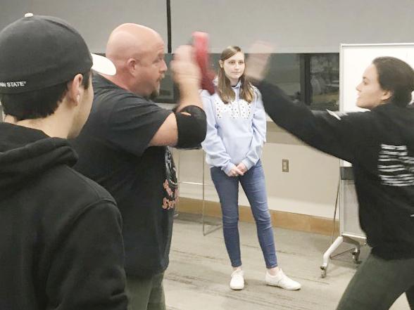 girl punches instructor during self defense class while others watch