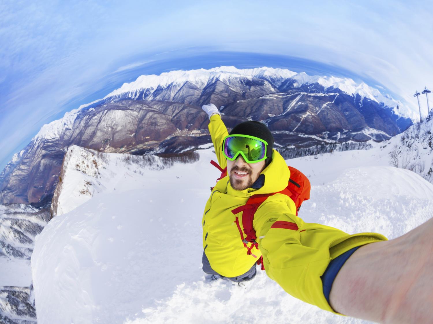 Man on mountain taking selfie