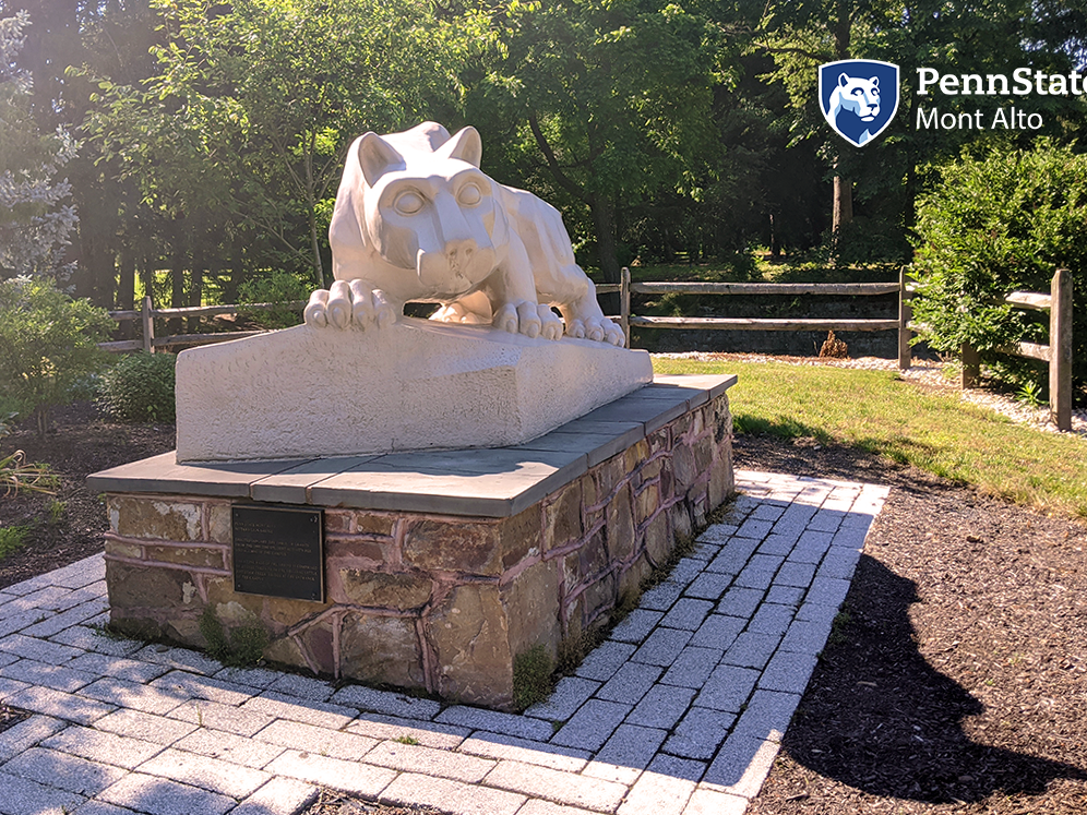 Sunny photo of shrine with Penn State Mont Alto logo