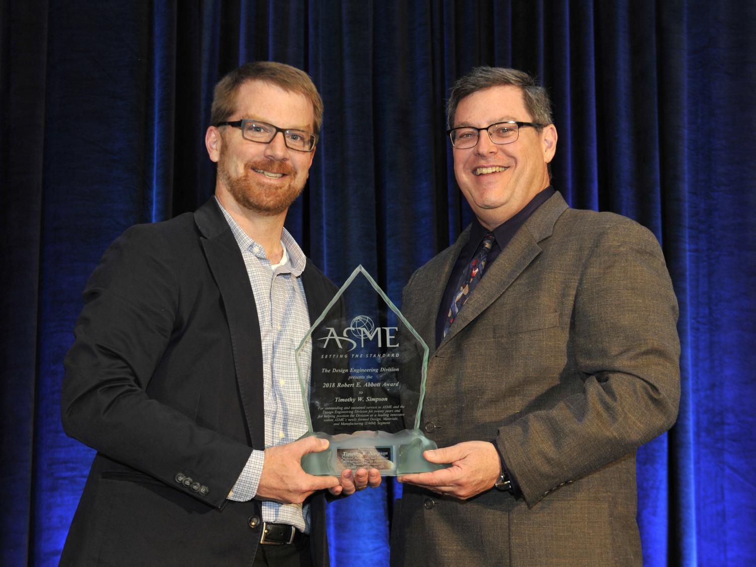 Tim Simpson receiving the Abbot Award from ASME