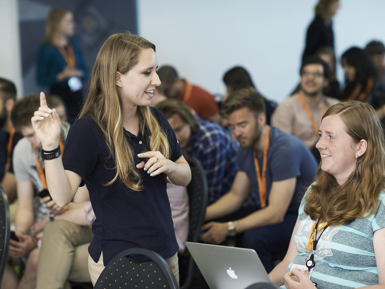 Jess Spoll provides tips to a student during a Communicating Scientific Research session.  