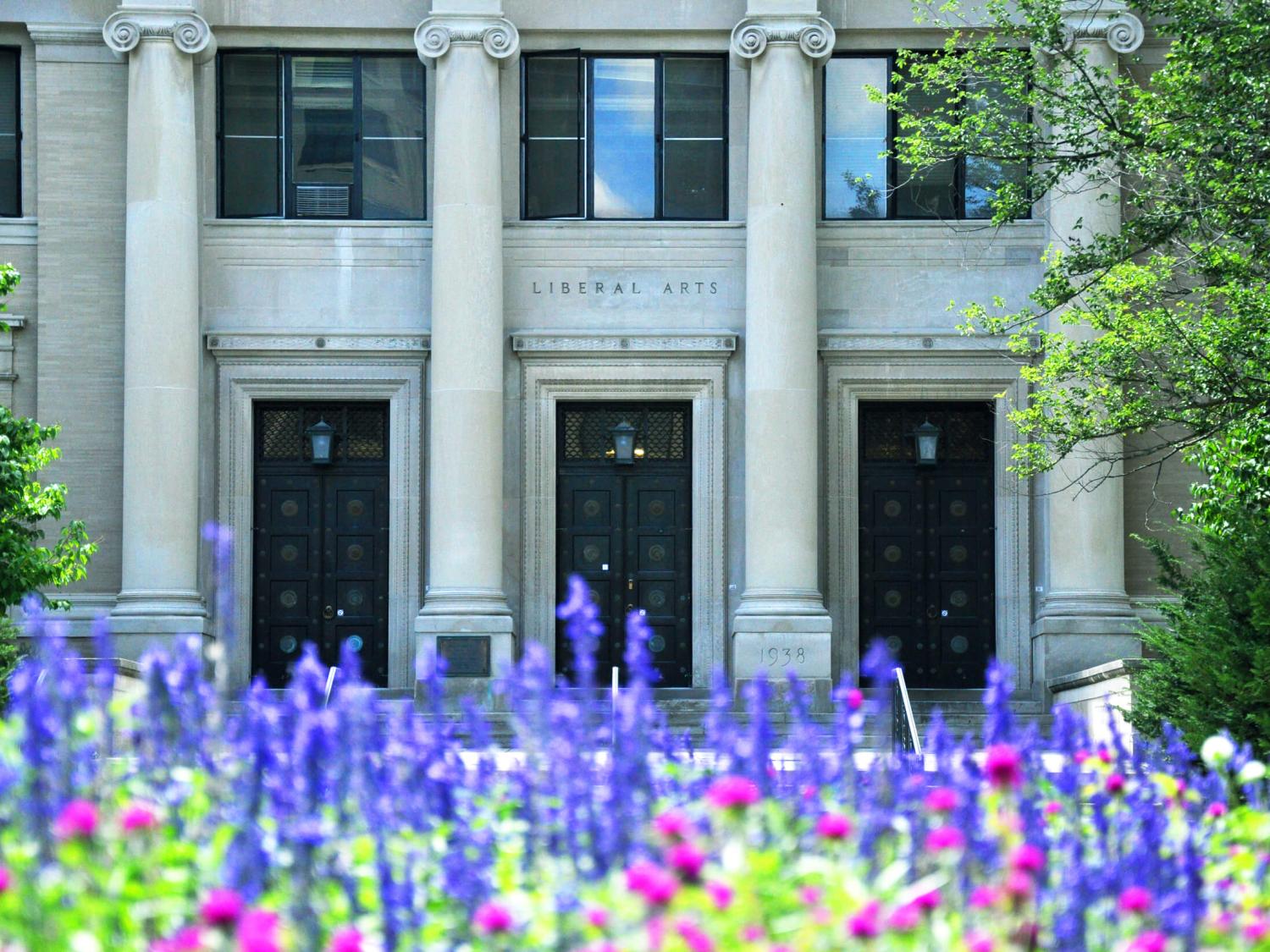 Sparks Building entrance with purple flowers in the foreground