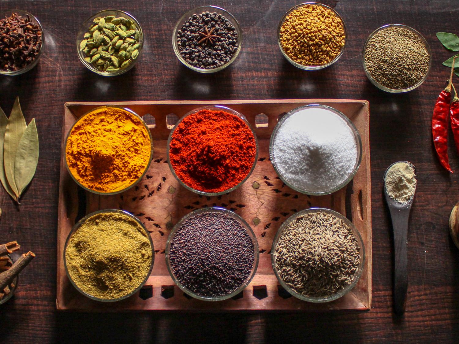 An array of brightly colored spices laid out on a table