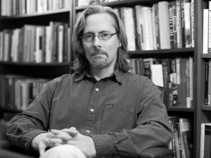 Stephen Berry sitting in front of a bookshelf