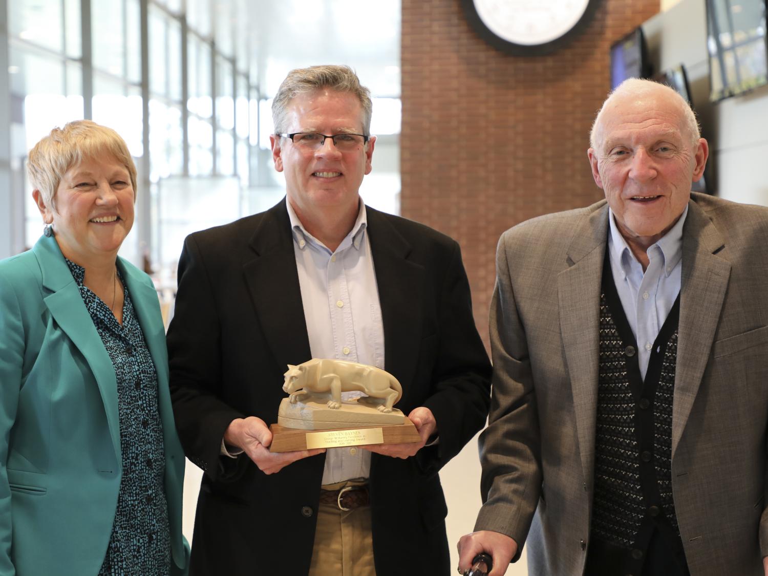 Steven Haynes receives his McMurtry award, presented by Mary Beth Rosson and George McMurtry. 