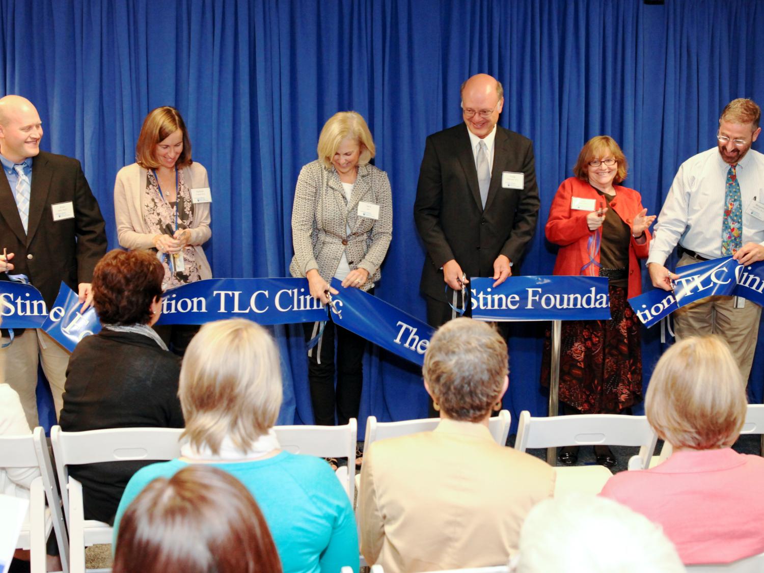 A ribbon is cut marking the grand opening of the James M. and Margaret V. Stine Foundation TLC Clinic, a service of the Penn State Hershey Center for the Protection of Children.