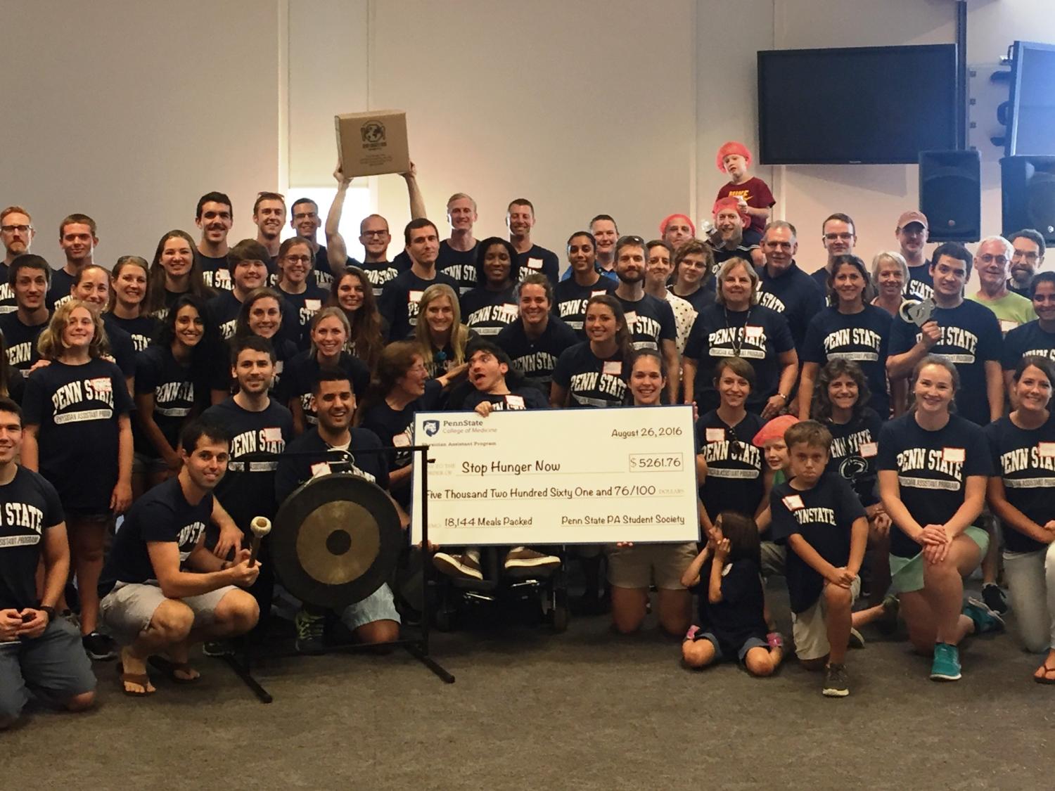 The Physician Assistant Program student class of 2017 poses with a check representing the money they raised for Stop Hunger Now.