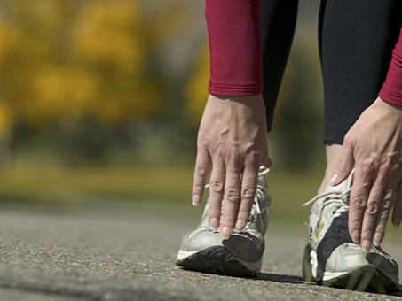 A woman touches her toes.