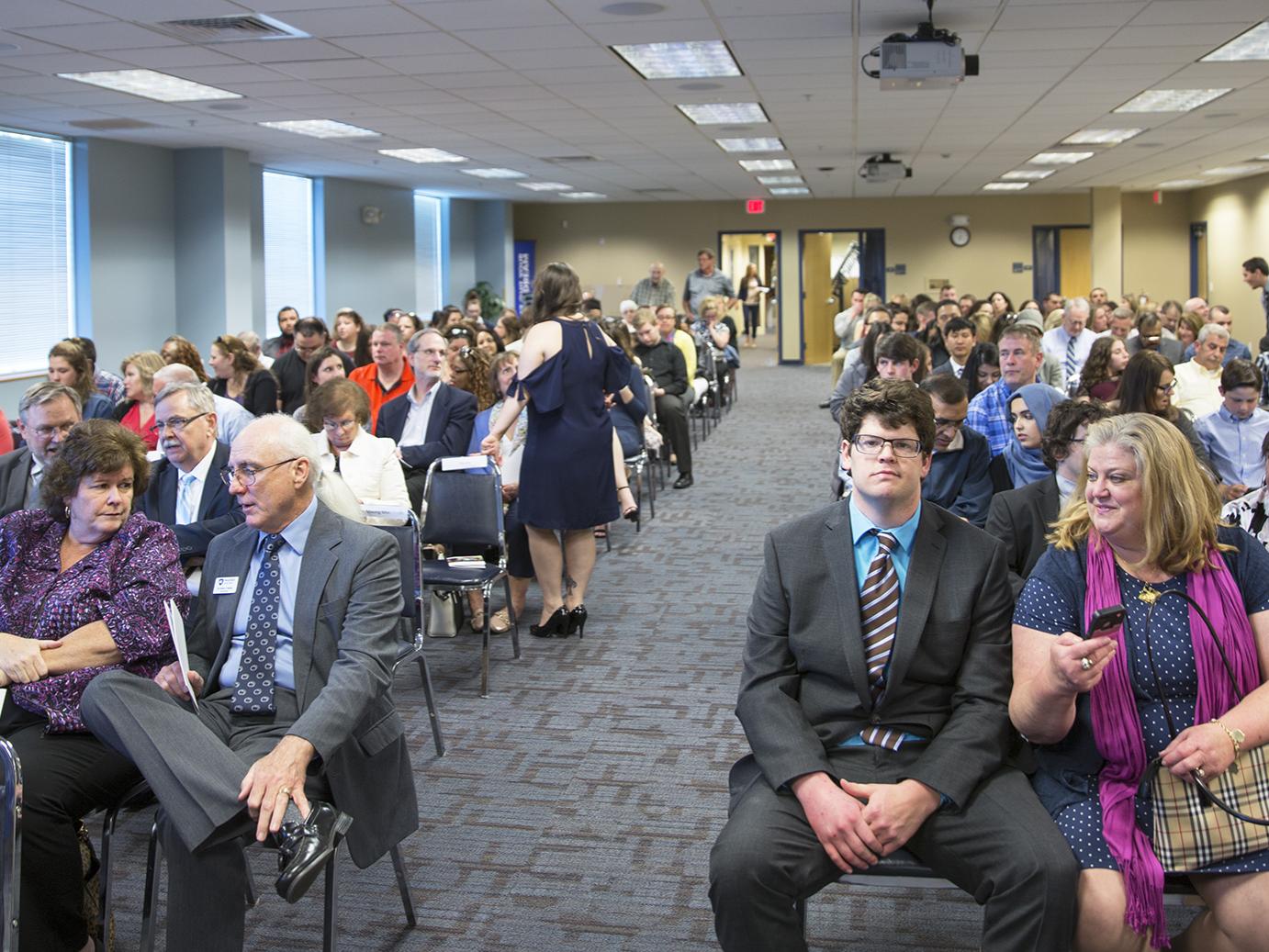a group of people seated in an auditorium