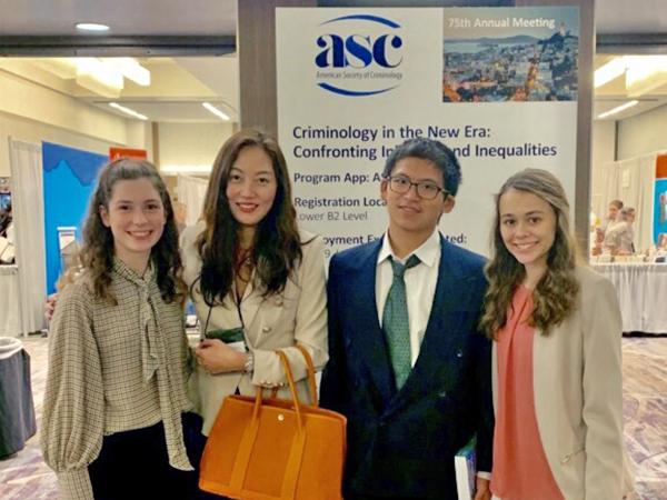 Four people stand in front of a sign that reads "ASC 75th Annual Meeting"