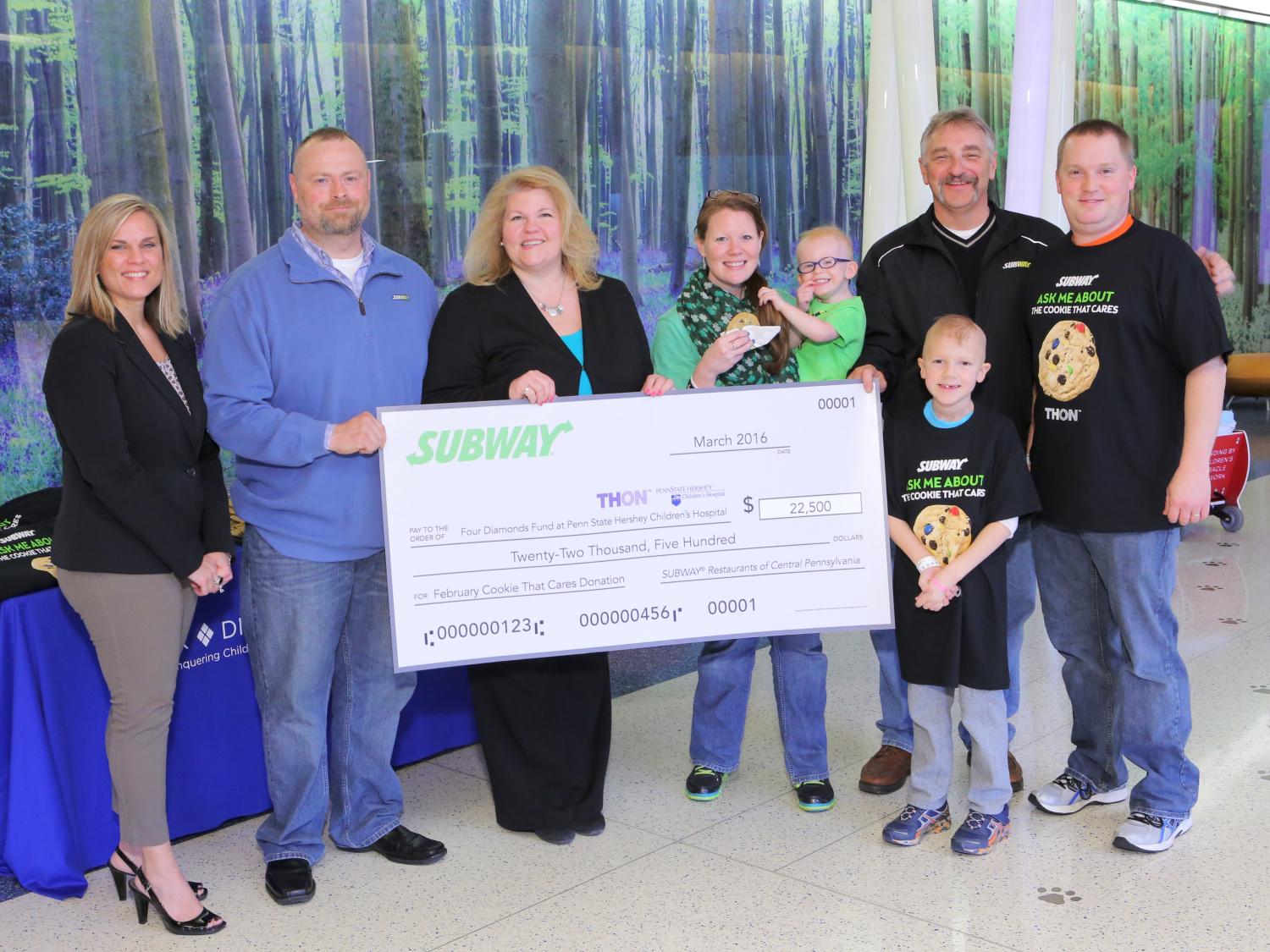Representatives of Subway restaurants and Four Diamonds pose with patient families.