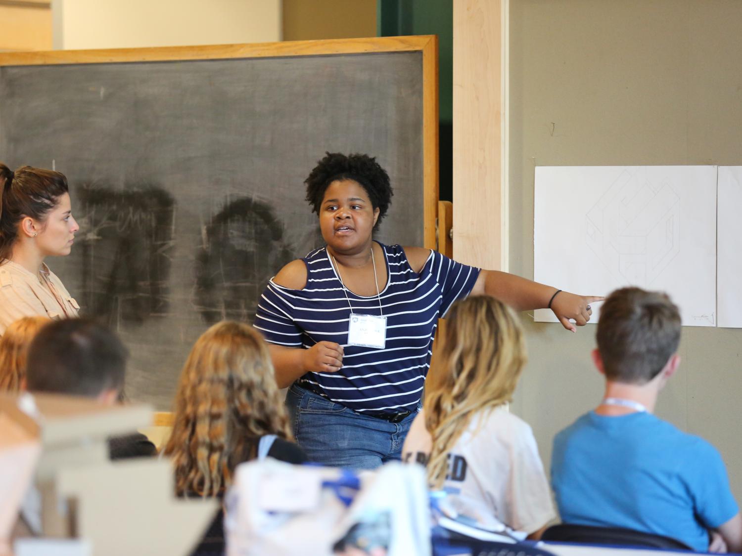 A Penn State landscape architecture student instructing summer camp participants