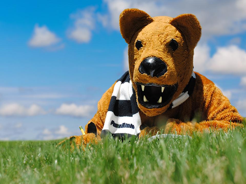 Nittany Lion laying on grass