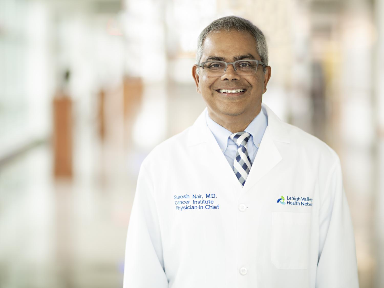 A man in a white lab coat