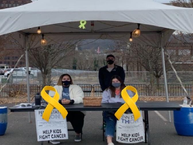Students staffing a table at Christkindlmarkt