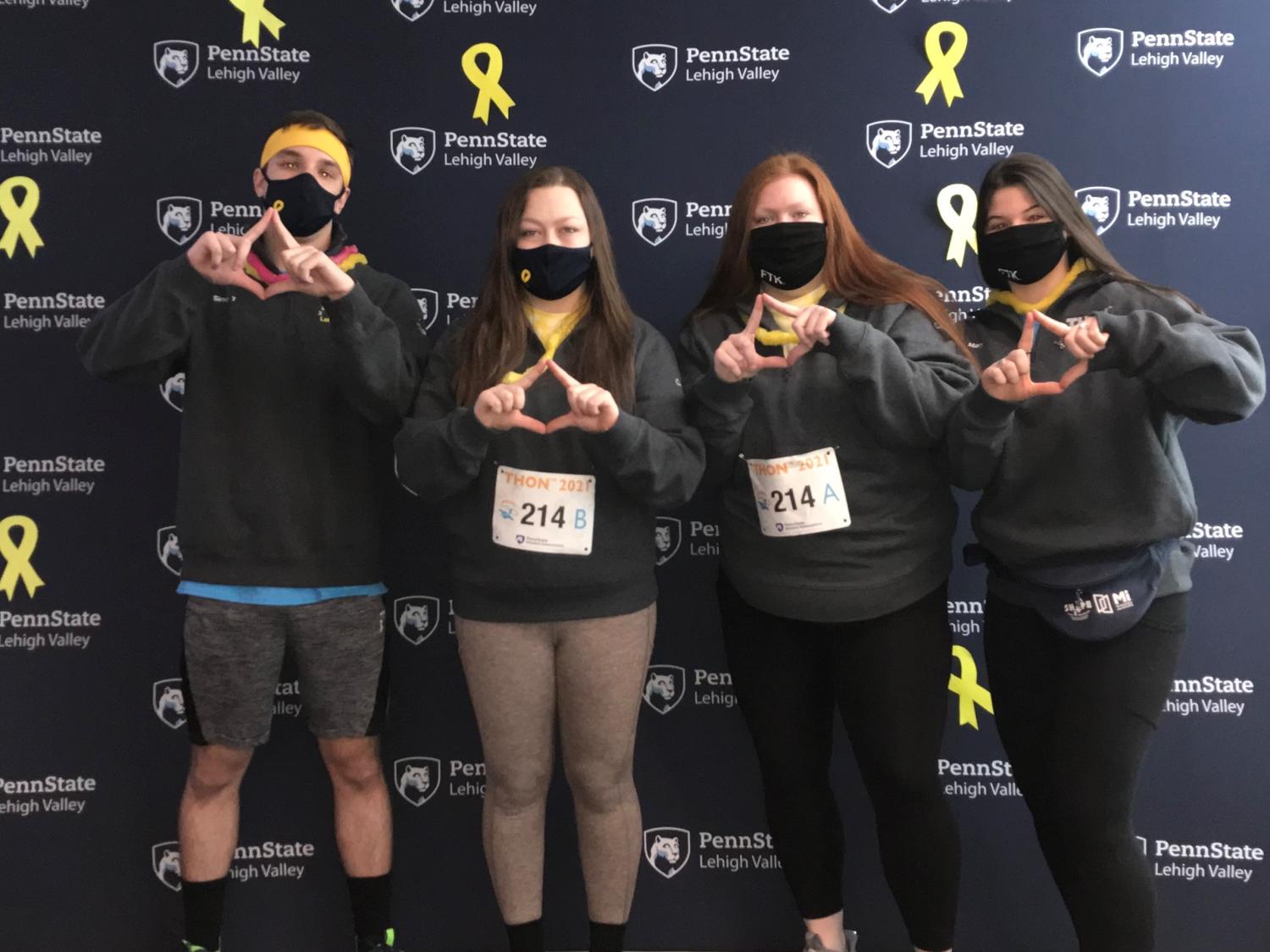 Students standing in front of a Penn State backdrop