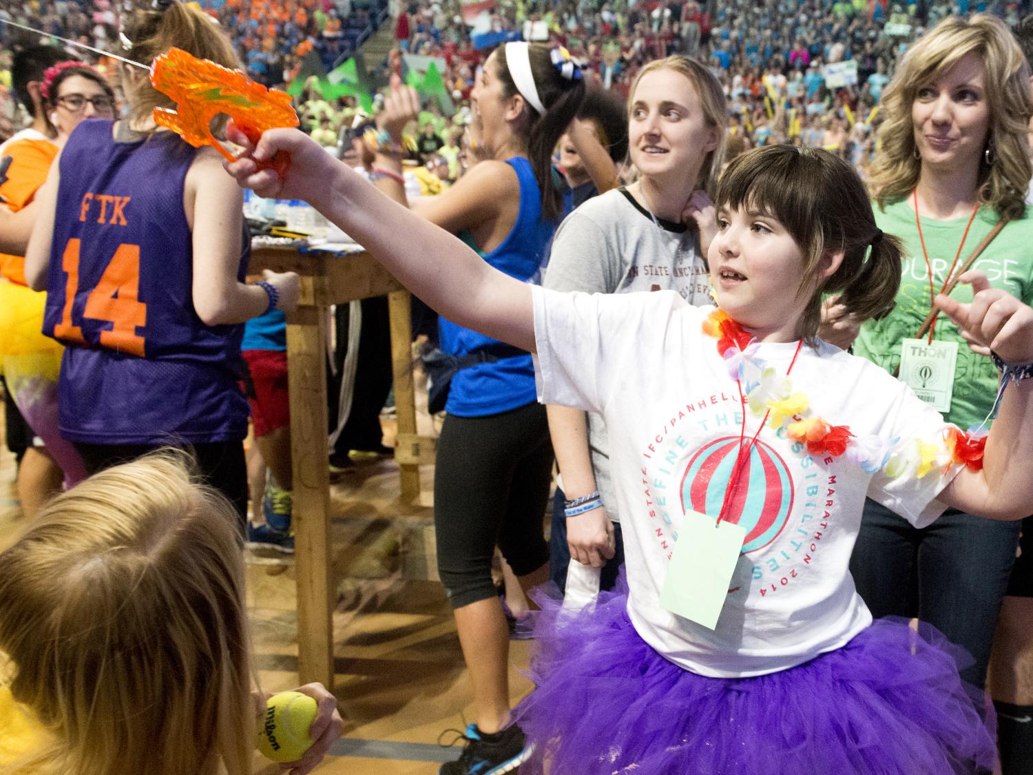 Kari Whitehead looks on as her daughter, Emily, plays at THON 2014.