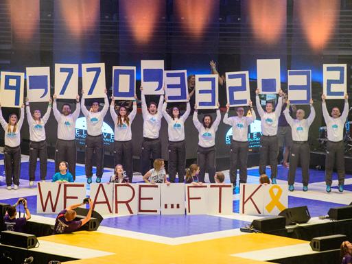 Penn State students reveal the total amount raised for the annual THON by holding up signs over their heads.